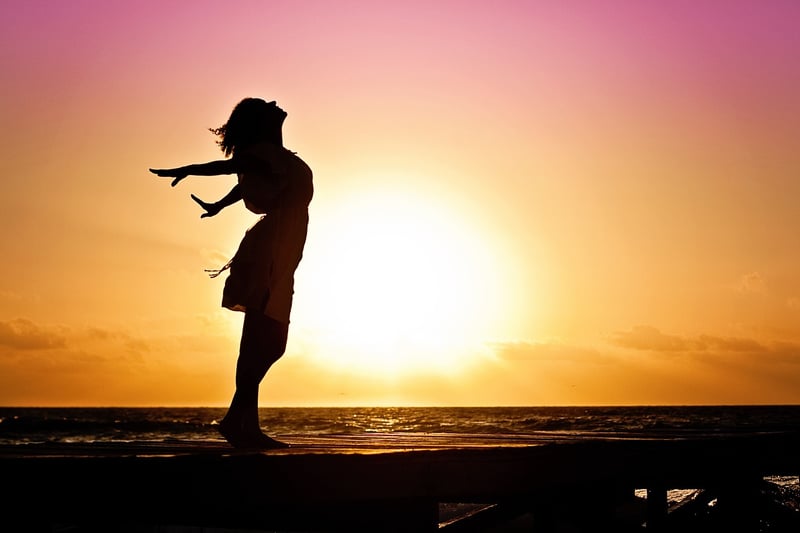 Woman practicing self-care at sunset